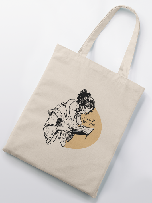 a tote bag with a drawing of a woman reading a book
